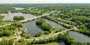 A large tree shading a home and cooling the air in the heat of summer in Tree Town USA.